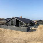 Modern wooden cabin with terrace and garden. View of the surrounding area.