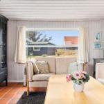 Living room with sofa, table, and view of the outdoor area.