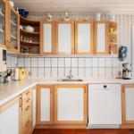 Kitchen with wooden cabinets, sink, and view of the outdoor terrace.