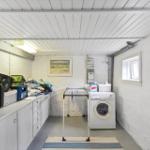 Room with washing machine, dryer, and kitchen counter.