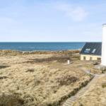 House next to windmill with view of the sea