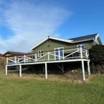 Green house with terrace and garden under blue sky