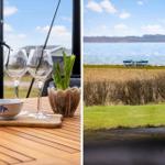 Tisch mit Wein und Gläsern vor Aussicht auf Wasser und Windräder