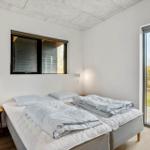 Bedroom with double bed, window, and glass door to terrace.