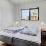 Bedroom with two mattresses, windows, and door to balcony.