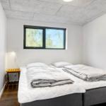 Bedroom with double bed, window, and nightstand.