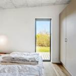 Bedroom with bed, wardrobe, and door to a terrace.