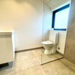 Bathroom with toilet, shower, and sink.