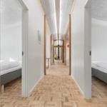 Long hallway with bedrooms and wooden floor