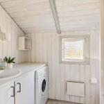 Bathroom with washing machine, mirror, and window
