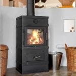 Black wood stove with burning fire, surrounded by baskets and a metal container.