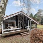 Wooden house with terrace and large window area in the forest