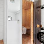 Bath with shower, sauna, and washing machine dryer combination.