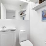 Bathroom with toilet, sink, and mirror