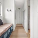 Bedroom with window, sofa and hallway with closet and curtain.