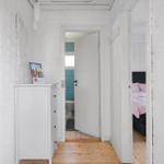 Hallway with white cabinet, bedroom, and bathroom with door handle.