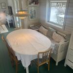 Dining room with round table, wooden chairs, and snowy view