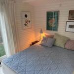 Bedroom with bed, window, and wall art.