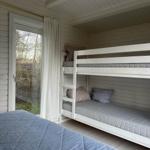 Room with bunk bed and sleeping space near window