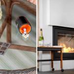 Tisch mit Spielzeug und Flasche neben Kamin mit brennendem Feuer.