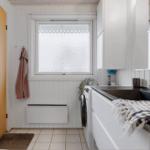 Utility room with washing machine, sink, and window
