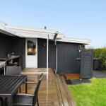 Outdoor area with grill, table, seating, and shower