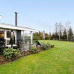 Modern villa with terrace, garden, and barbecue area.