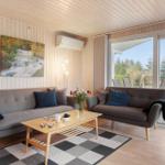 Living room with two sofas, table, and view of garden.