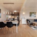 Living and dining area with kitchen, sofa, and dining table.