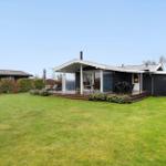 Modern villa with terrace, garden, and seating areas.