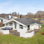 House with terrace and garden. View of lake and forest.
