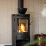 Wood-paneled wall with wood-burning stove and fire