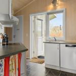 Kitchen with sink, dishwasher, and window to outside door.