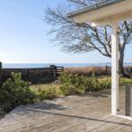 Deck with sea view and a tree.