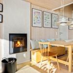 Room with dining table, bench, and fireplace against white wall.