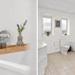 Badezimmer mit Badewanne, Toilette und Fenstern mit Pflanzen.