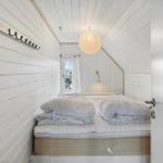 Schlafzimmer mit Bett, Fenster und Deckenleuchte.