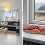 Wohnzimmer mit grauem Sofa und Holztisch. Fensterbank mit roten Fischfiguren.