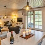 Ein Raum mit Esstisch, Kamin und Wohnbereich mit Sofa und Fernseher.