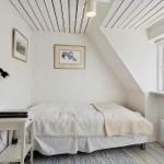 Bedroom with sloped ceiling, window, and bed