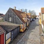 Village street with traditional houses and cobblestone pavement