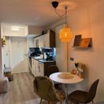 Kitchen with dining area and warm lighting on the wall.