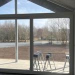 Große Glasfront mit Blick auf Außenbereich und Bäume