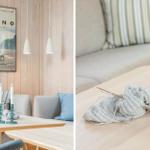 Living room with sofa, table, and wall poster. Knitting project lies on the table.