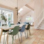 Dining area with table, chairs, and view of the terrace.