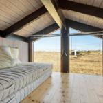 Bedroom with bed and view of the landscape.