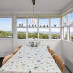 Esszimmer mit Blick aufs Meer und großen Fenstern.