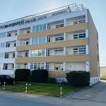 Mehrfamilienhaus mit Balkonen und gepflegtem Vorgarten