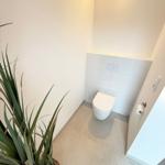 Bathroom with toilet and plant