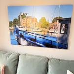 View of harbor with boats and historic buildings on the wall.
